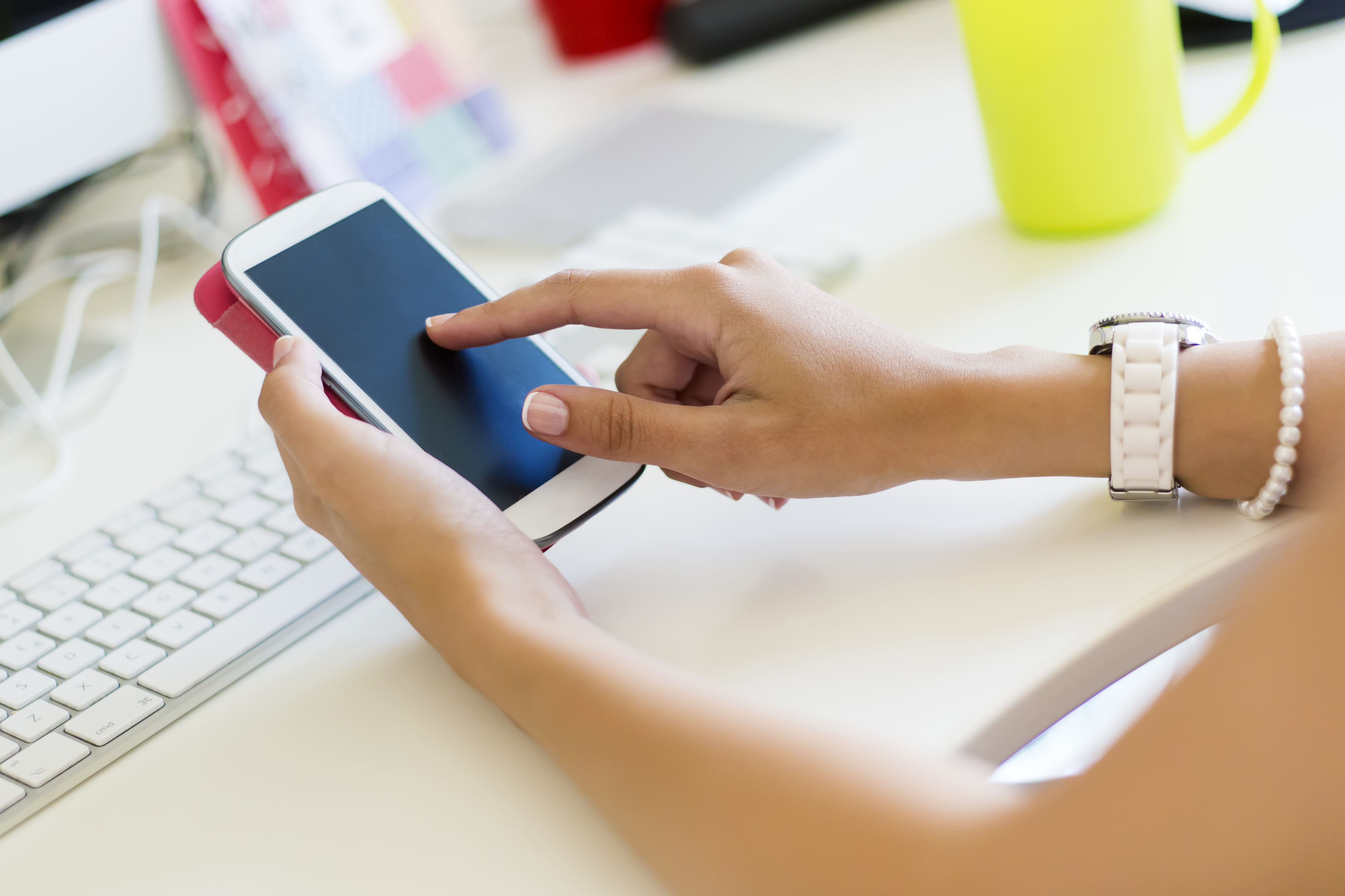faceless-female-using-smartphone-sitting-by-table.jpg